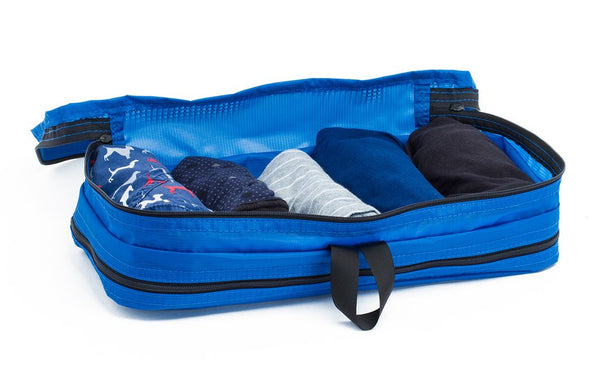 Five pairs of underwear rolled in a Island (blue) Aether Small Laundry Aeronaut 45 Packing Cube.